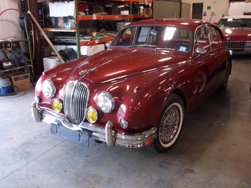 Red classic Jaguar Mark II sedan.
