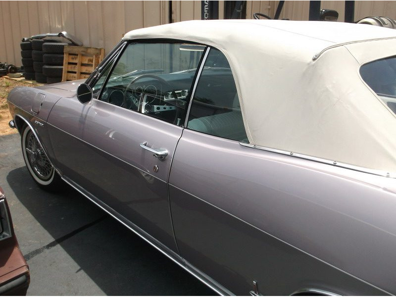Purple classic convertible car side view.