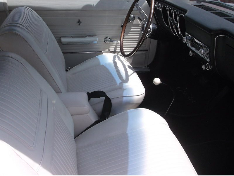 Classic car's interior, white seats.
