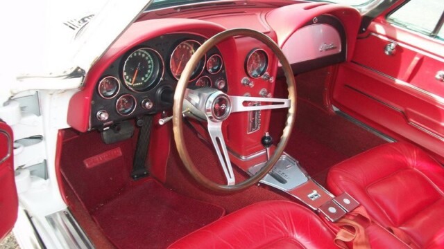 Vintage Corvette red cockpit with wooden steering wheel