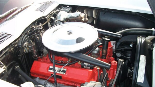 Red 327 Chevy engine in a classic car.