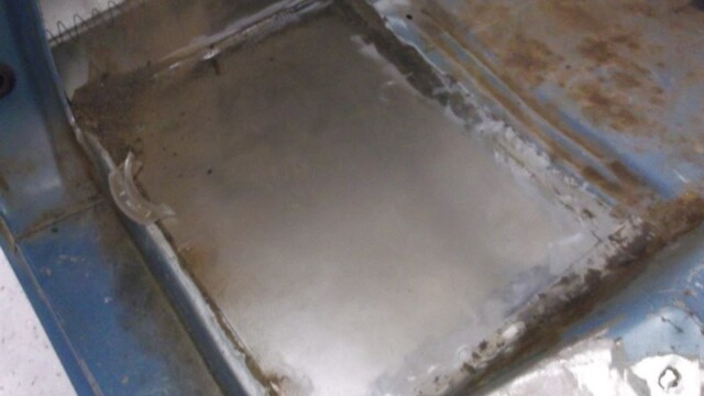 Car floor panel rust repair in progress.