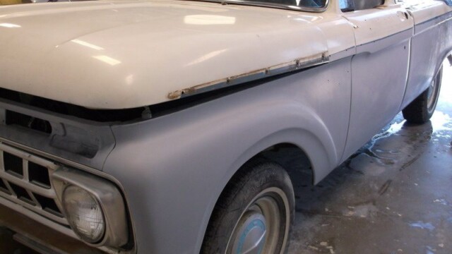 Primered vintage Ford pickup truck.