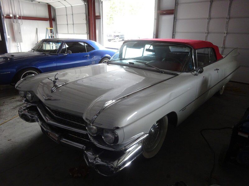 White Cadillac convertible in garage.
