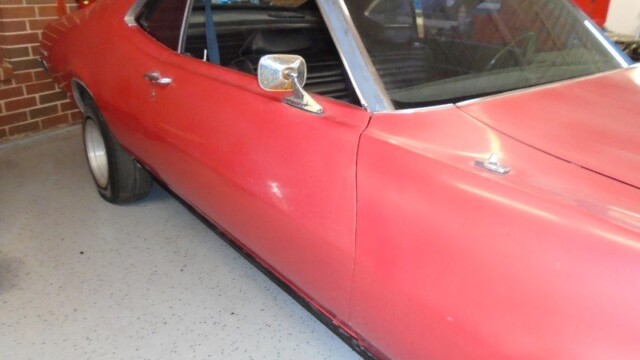 Red vintage Ford Maverick car.
