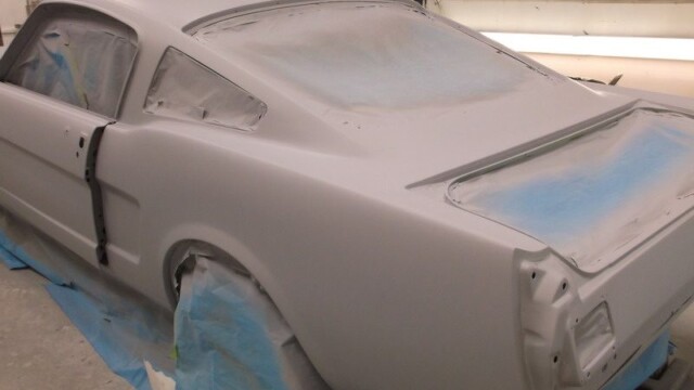 Primered classic Ford Mustang in shop.