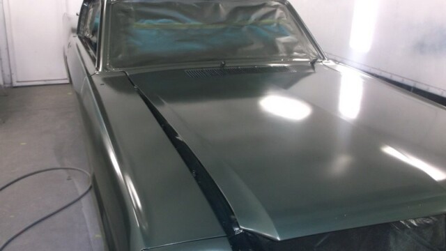 Dark green classic car, freshly painted.