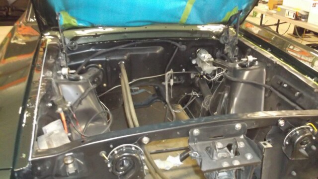 Green classic car engine bay restoration.