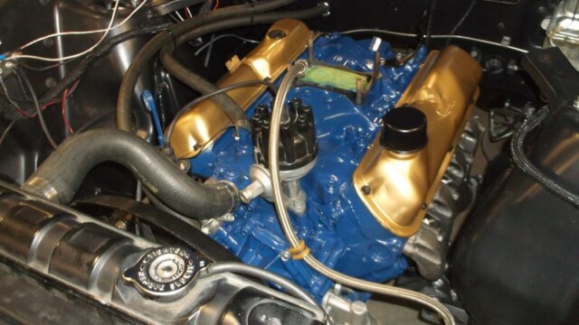 Blue and gold classic car engine.