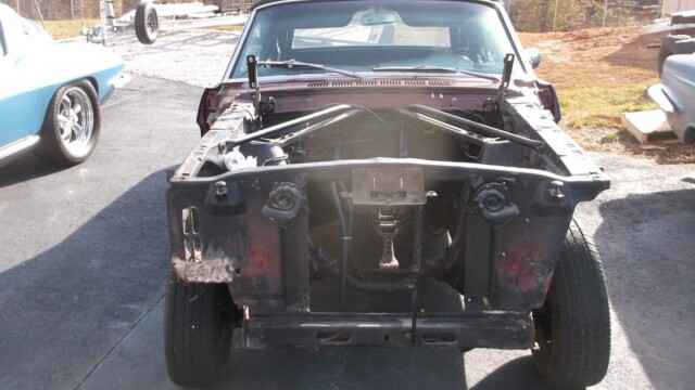 Stripped down classic car engine bay.