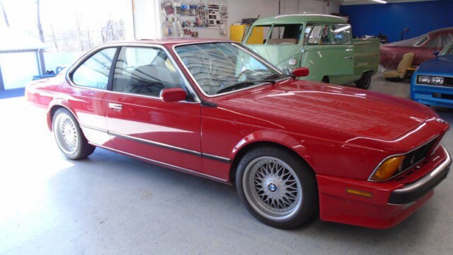 Red BMW M6 in garage.