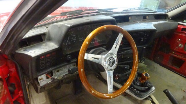 Red car's interior under construction.