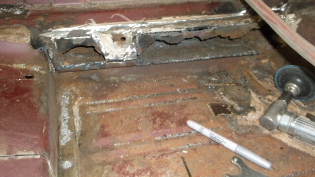 Corroded vehicle floor with marker and tools