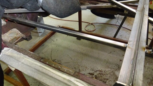 Exposed steel frame rails over workshop floor