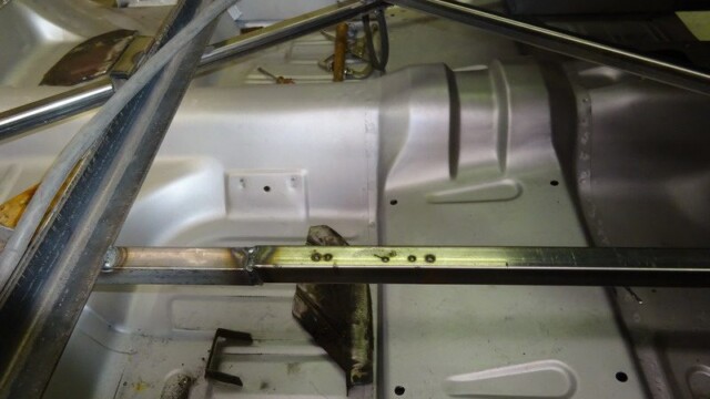 Silver car floor pan with welded crossbars