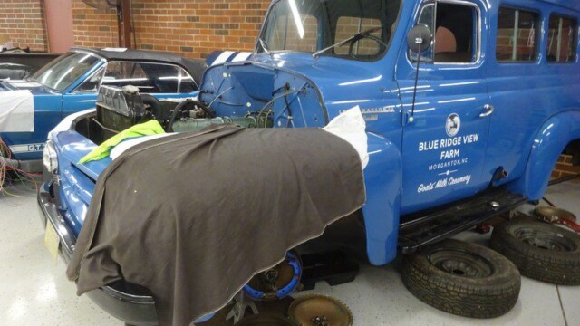 Blue vintage truck under repair.