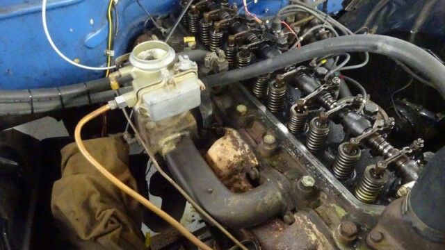 Classic car engine, carburetor, and valves.