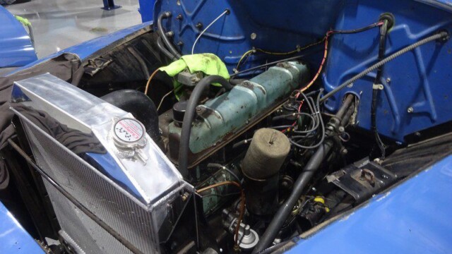 Blue classic car engine bay detail.