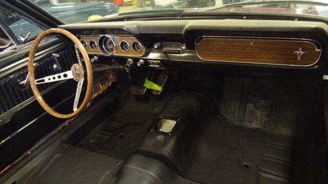Classic Mustang dashboard with wood glovebox and wheel
