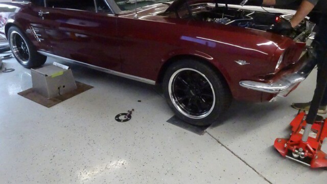 Red Ford Mustang under repair.