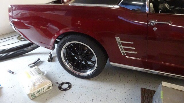 Burgundy vintage Mustang rear quarter with wheel