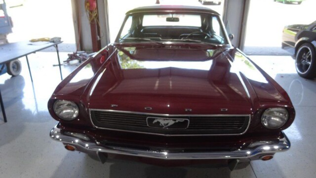 Classic maroon Ford Mustang convertible.