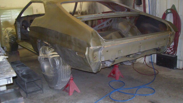 Vintage coupe body on red jack stands