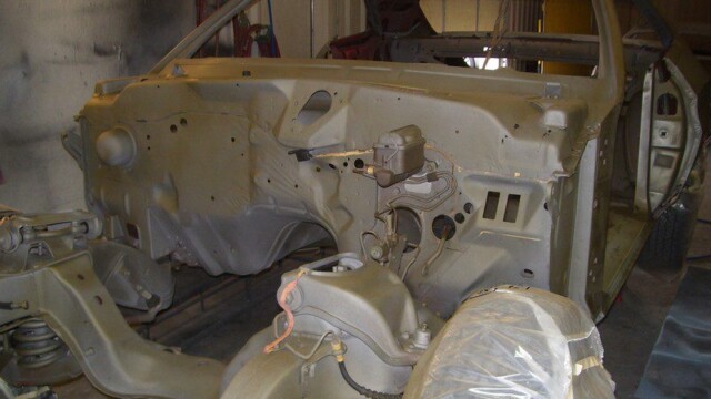 Stripped chassis and engine bay after primer