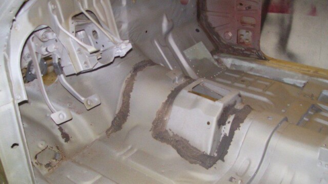 Car floor pan restoration in progress.