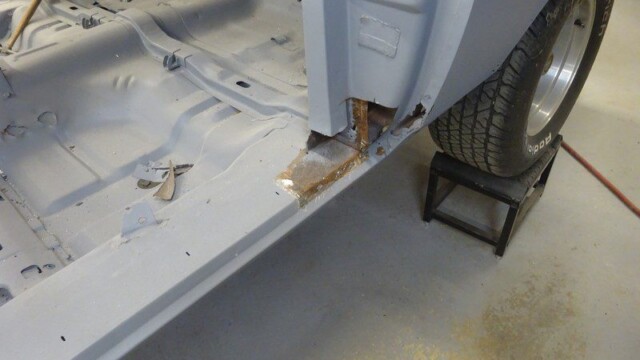 Car body repair; rusted floor panel.