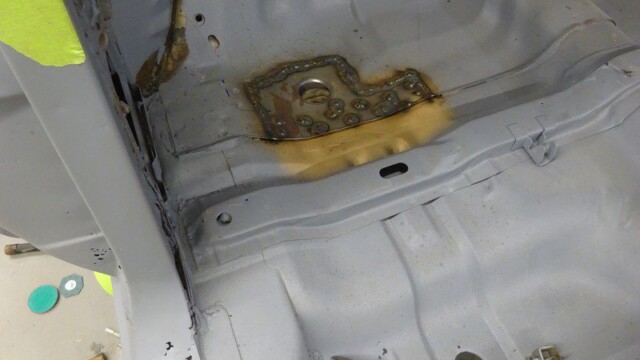 Welded patch plate near rear footwell