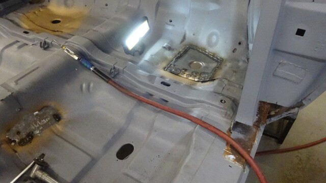 Car interior floor pan with welded patch