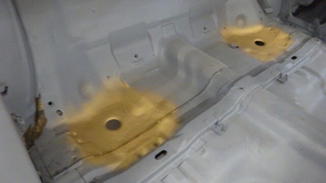 Rear footwell primed with rust repair spots