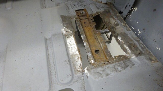 Car floor with rust repair in progress.