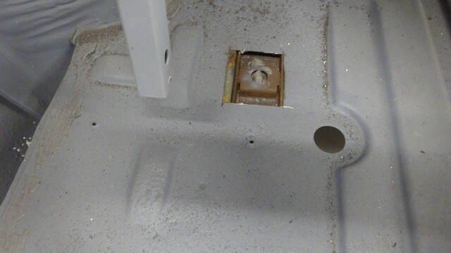 Painted car floor with bolted support.
