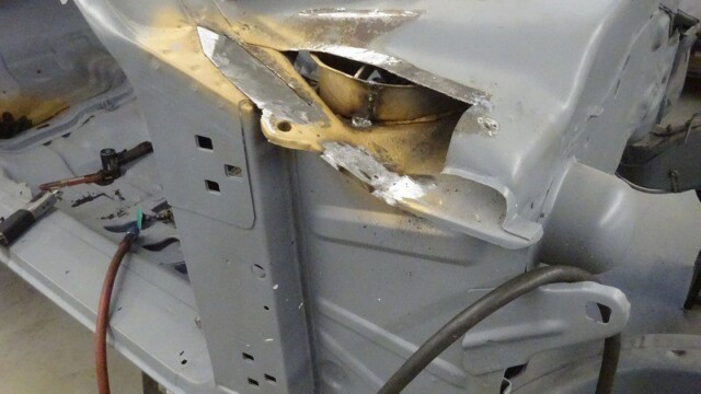 Car body repair, metal welding in progress.