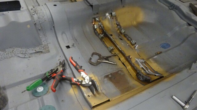 Pliers and clamps laid on car floor