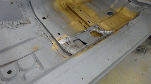 Primed passenger floor pan with exposed seam