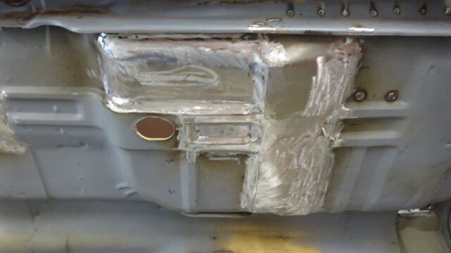 Close-up floor pan patch with oval access hole