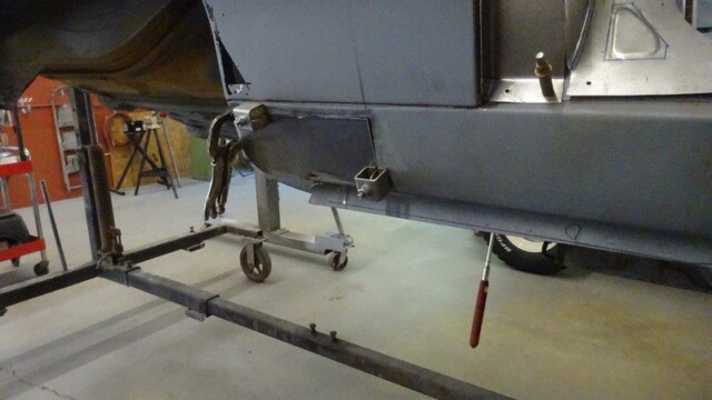 Car body repair in progress on a stand.