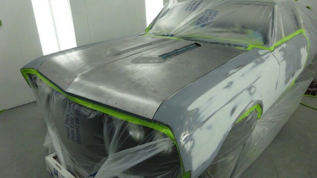 Classic car body in paint booth.