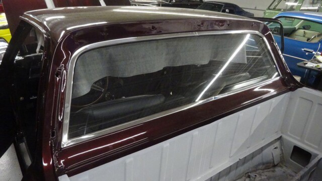 Dark red classic car truck bed.