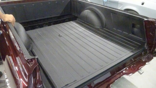 Black textured bed liner in maroon El Camino