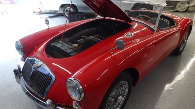 Red MG MGA classic car engine view.