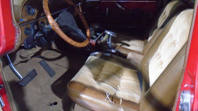 Red classic truck interior, brown seats.