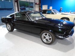 Black classic Ford Mustang in garage.