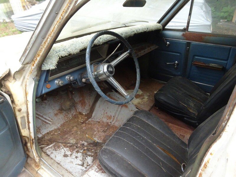 Rusty classic car interior, needs restoration.