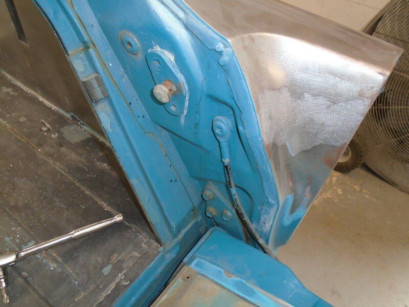 Blue car body repair in progress.