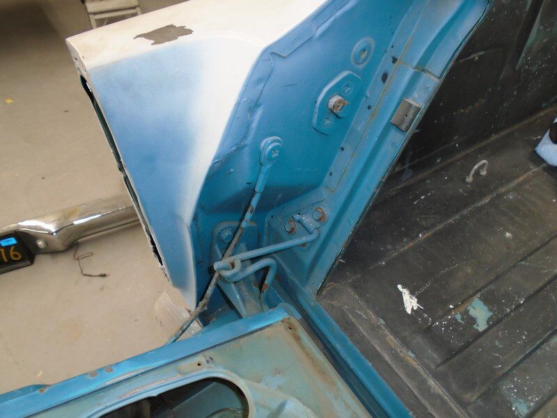 Blue classic car trunk repair.