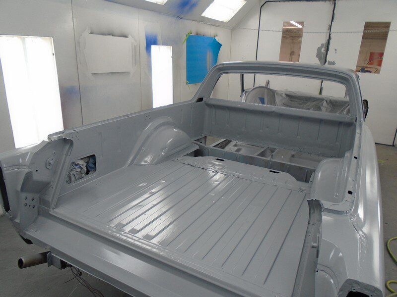 Here's an alt tag for the image: Gray primered ute truck bed.